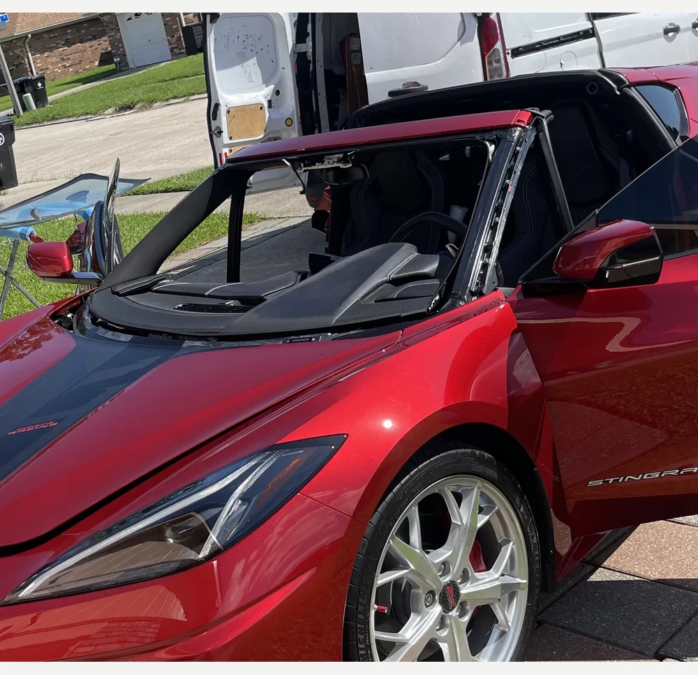 Red Corvette windshield. Windshield removed.